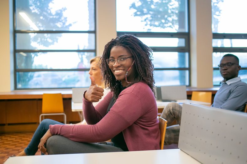 Black woman showing thumb up to camera