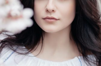 Woman behind cherry blossoms