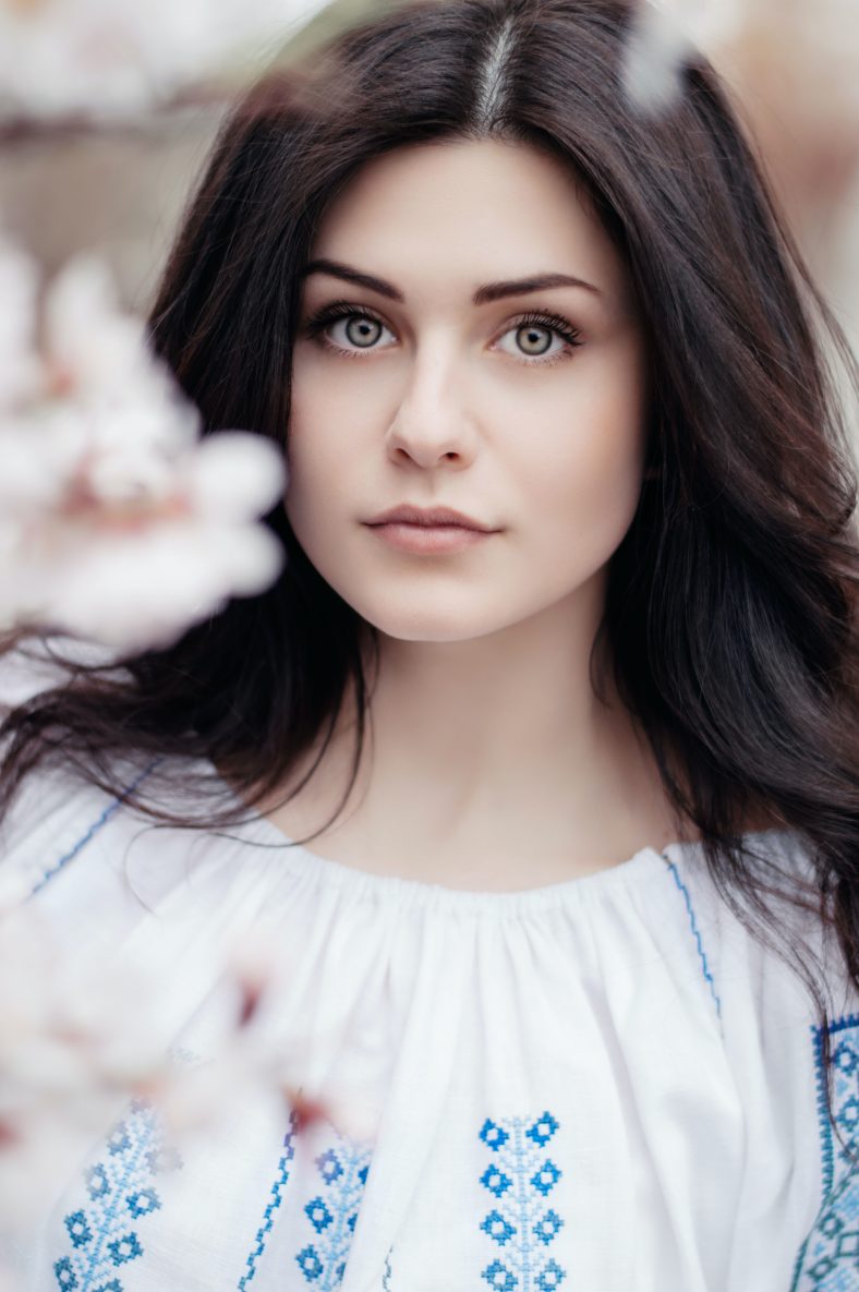 Woman behind cherry blossoms