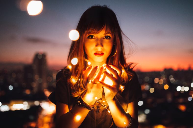 Woman holding fireflies