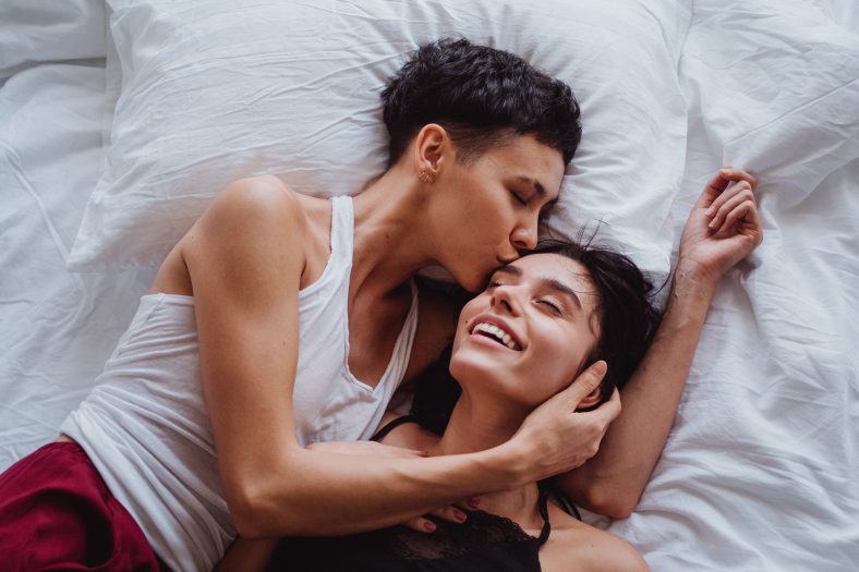 Woman kissing another woman on the forehead